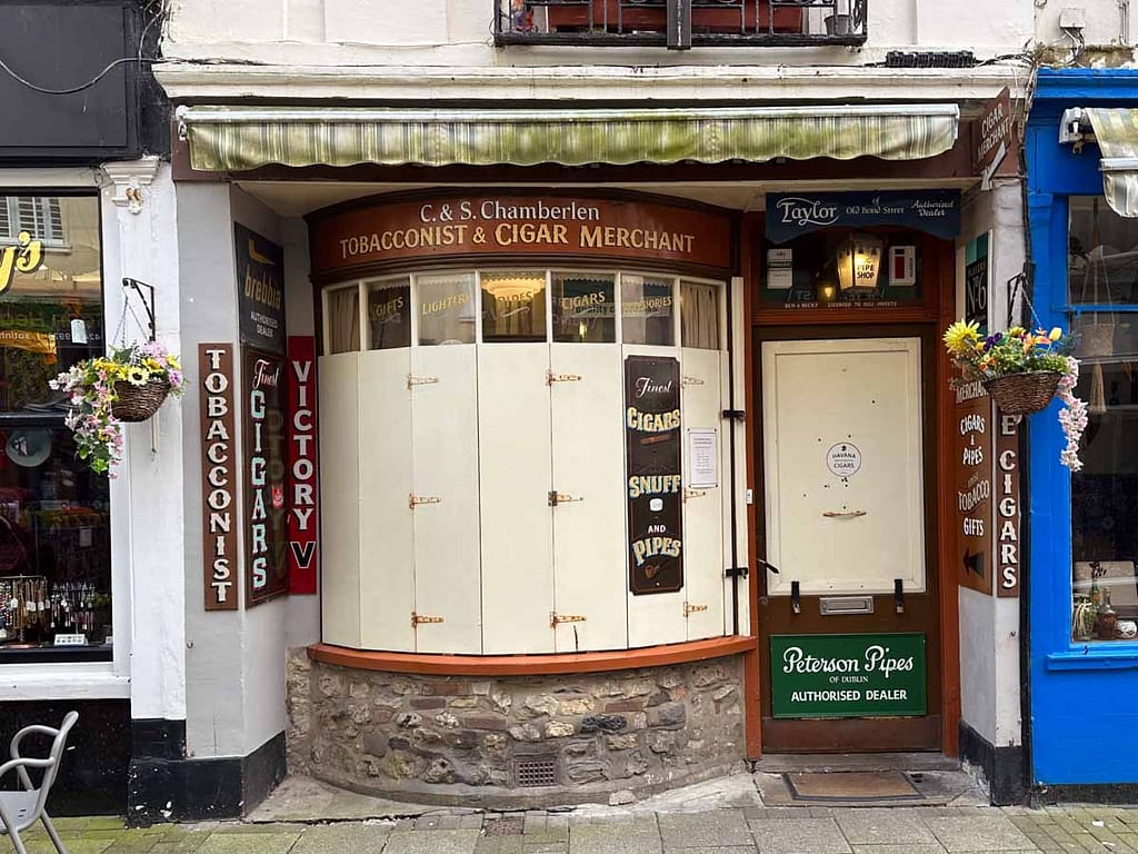 The tobacconist & Cigar Merchant closed, with its shutters across.