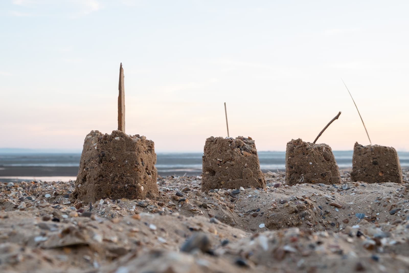 4 sandcastles in a line on Chalkwell Beach, Southend on Sea